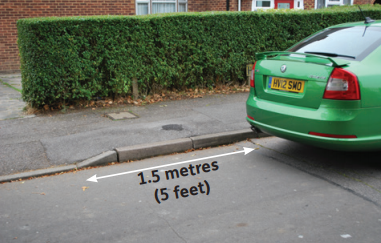 image of a car parked 1.5 meters away from the dropped kerb