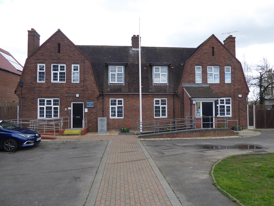 Red-bricked building, with path and flagpole