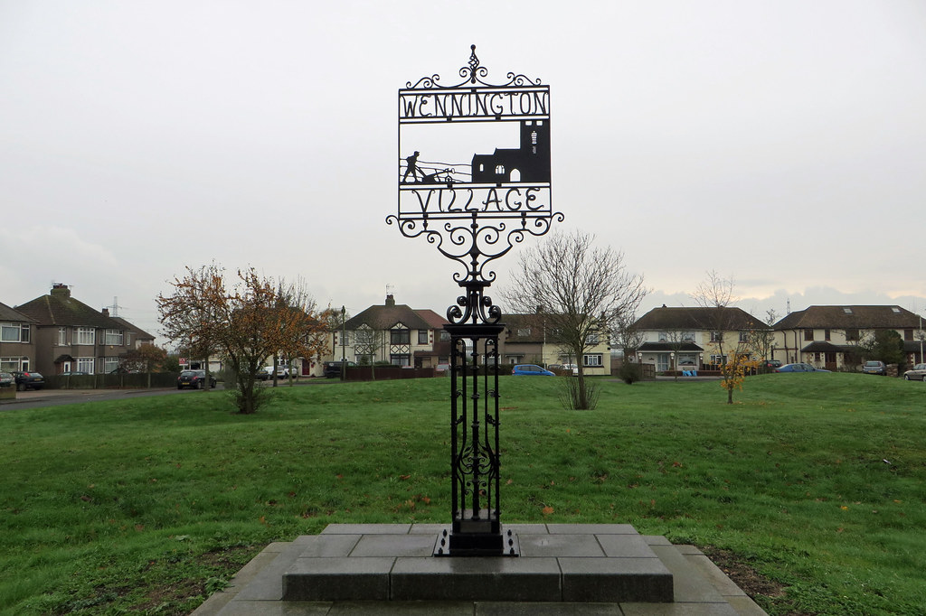 Image of Wennington green sign with grass in background