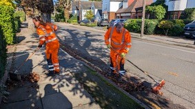 Street cleaning teams sweeping leaves on the streets